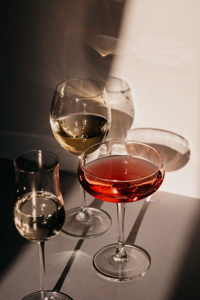 Diverse wine glasses casting shadows in warm sunlight. Perfect for lifestyle and dining concepts.